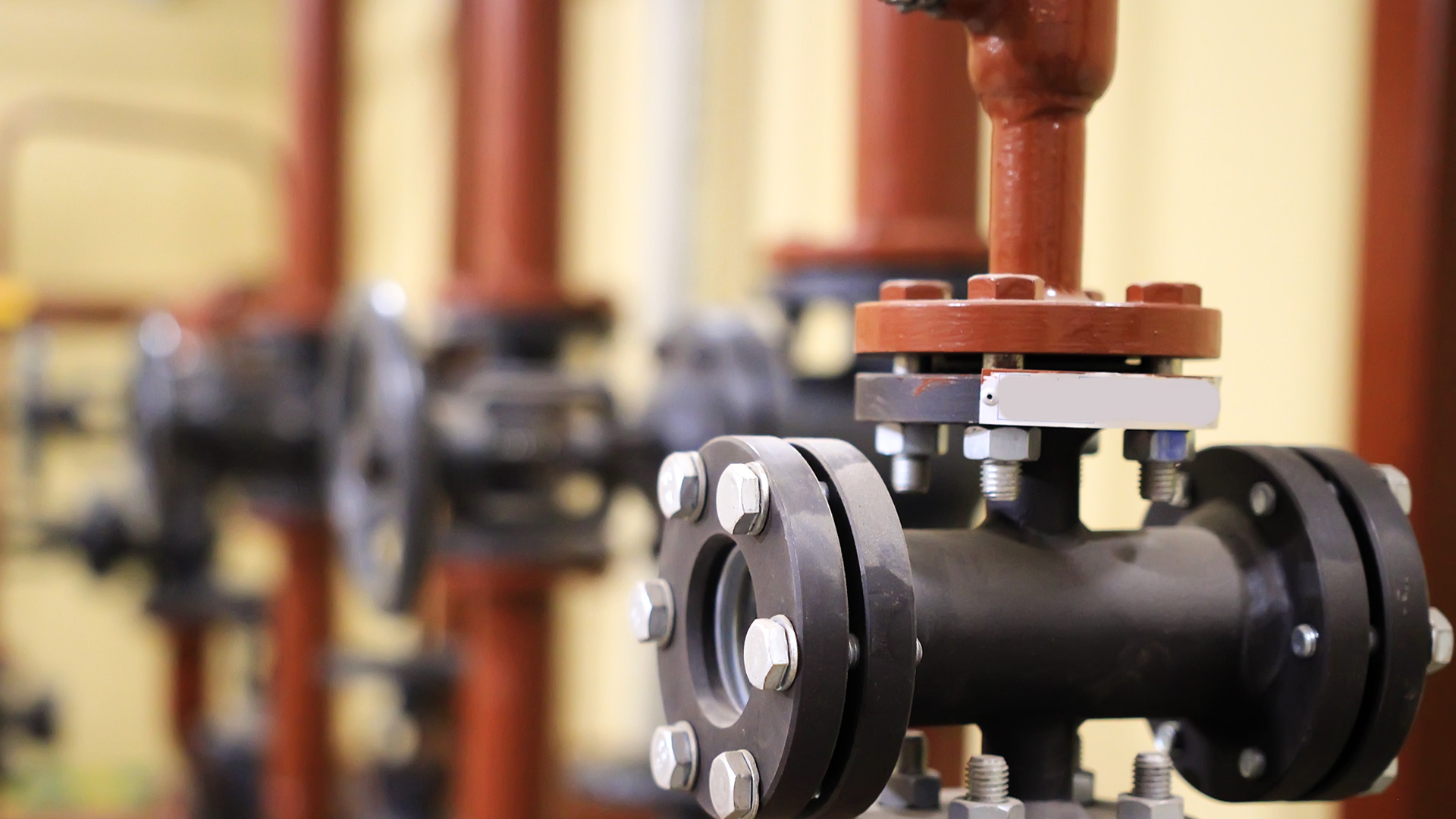 A close-up image of a gate valve in industrial pipelines.